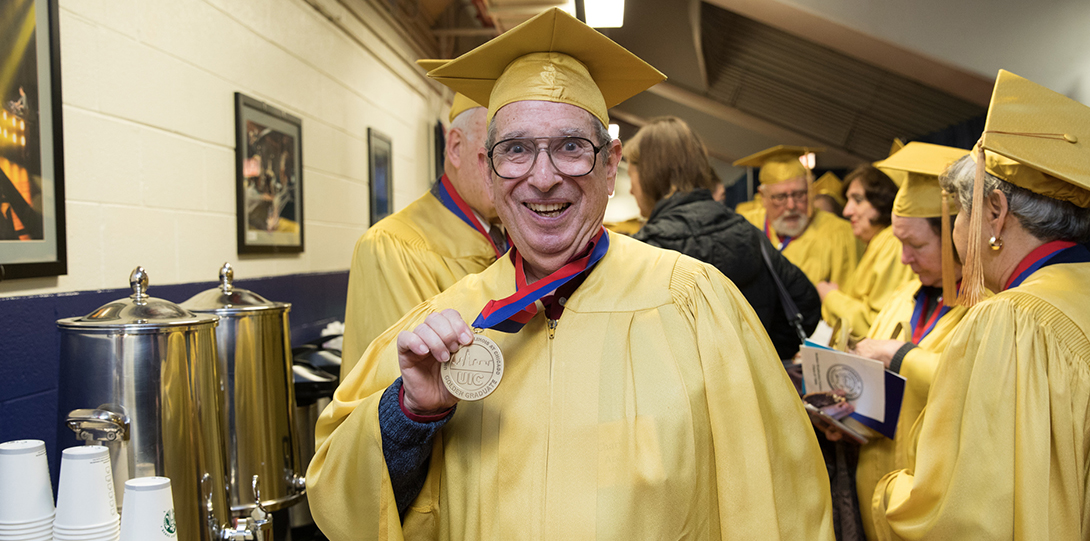 Golden graduate with a UIC graduate medallion