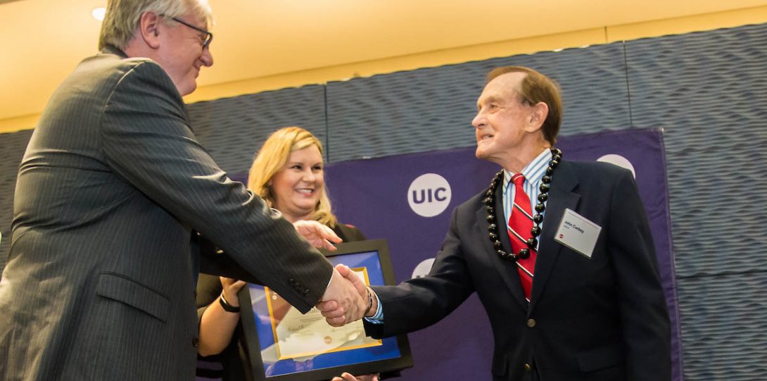 Chancellor Michael Amiridis presents awards at the 2019 UIC Alumni Award Celebration 