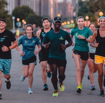 UIC alumnus and architect Kerl LaJeune (center) leading a group of runners
                  