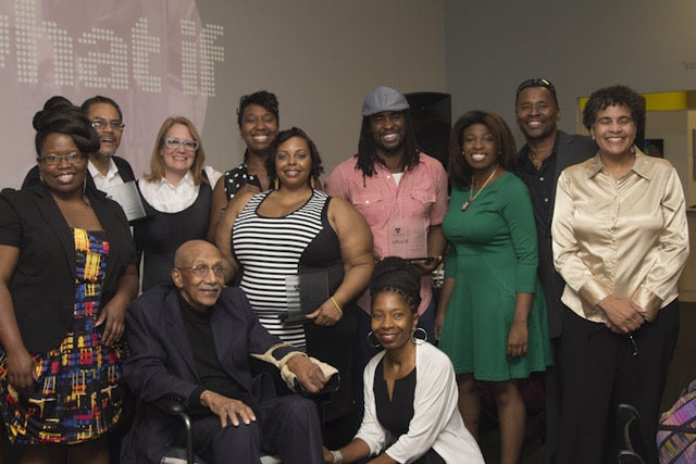 A group of twelve people posing for a photo