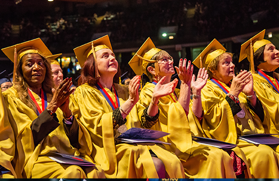 Golden Grads wearing golden colored caps and gowns