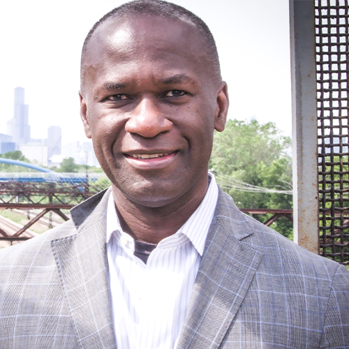 Portrait of UICAA president-elect Kerl LaJeune wearing a blazer and collared shirt with the Chicago skyline in the background.