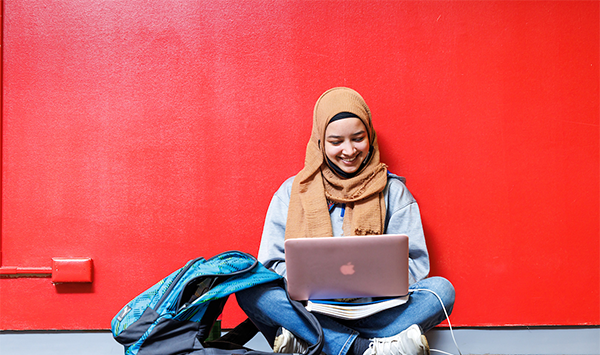 Students working at computers in a classroom.