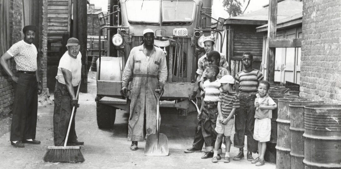 Men and children clean up an alley