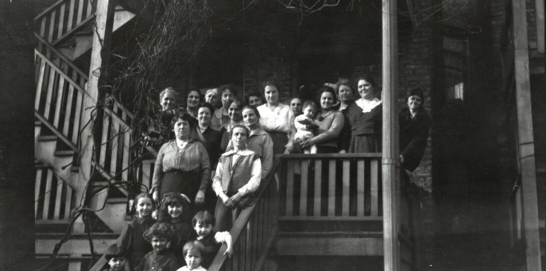 Women and children on back stairs of building