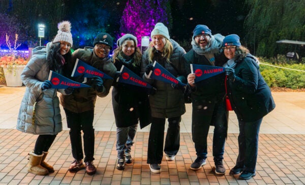 Group of UIC alumni holding UIC pendants at the UIC Alumni Night @ Lightscape.