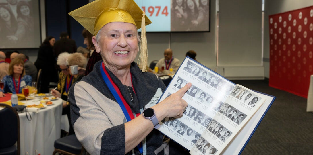 A Golden Grad points to themselves in a 1974 yearbook.