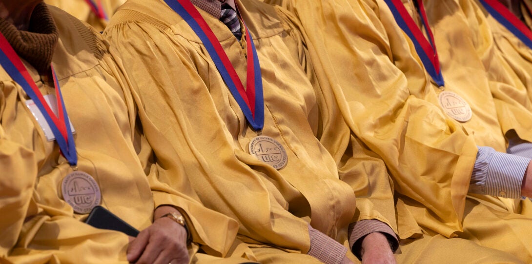 Golden Grads wearing medallions around their necks.