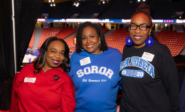 Group photo of three people at the Umoja reception.